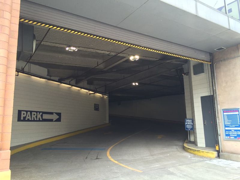 Automated parking garage door at the entrance to a parking lot.