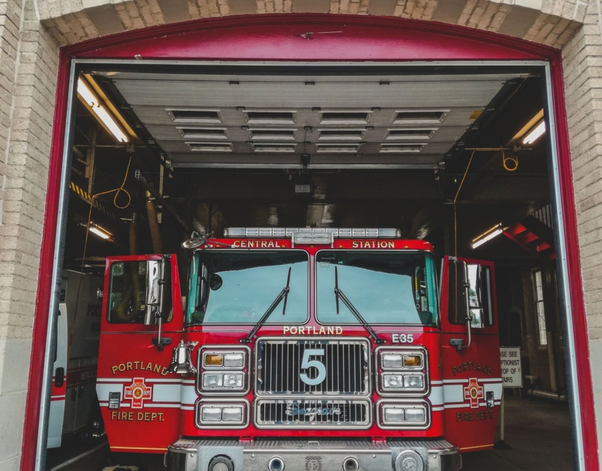 A Portland Fire Department Truck seen through the large open doorway of a fire station. A Portland Fire Department Truck seen through the large open doorway of a fire station.